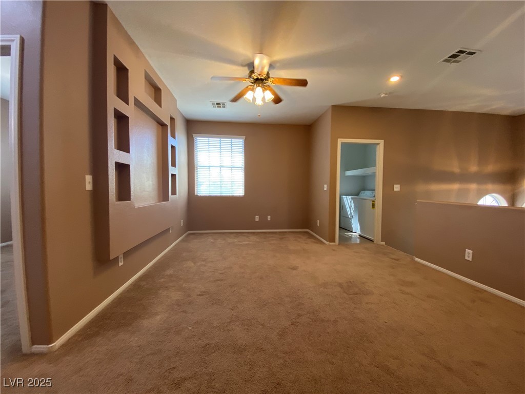5680 Arrow Tree Street Las Vegas, NV 89130 - Photo 11 of 27 Empty room with carpet, ceiling fan, and washer and clothes dryer