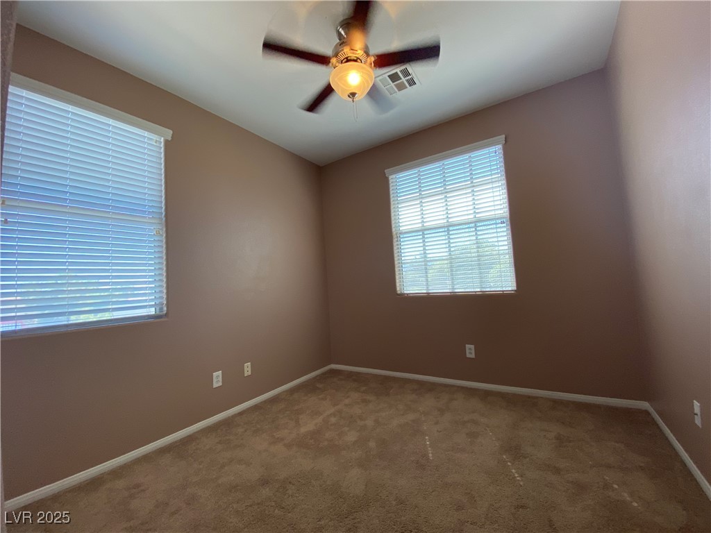 5680 Arrow Tree Street Las Vegas, NV 89130 - Photo 18 of 27 Spare room featuring a ceiling fan and carpet flooring