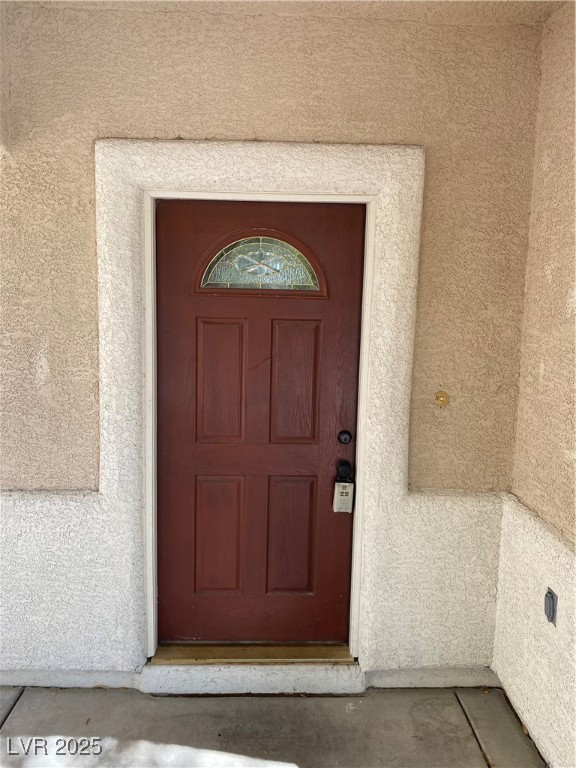 5680 Arrow Tree Street Las Vegas, NV 89130 - Photo 2 of 27 Property entrance with stucco siding