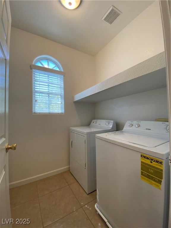 5680 Arrow Tree Street Las Vegas, NV 89130 - Photo 24 of 27 Washroom featuring light tile patterned floors and washer and dryer