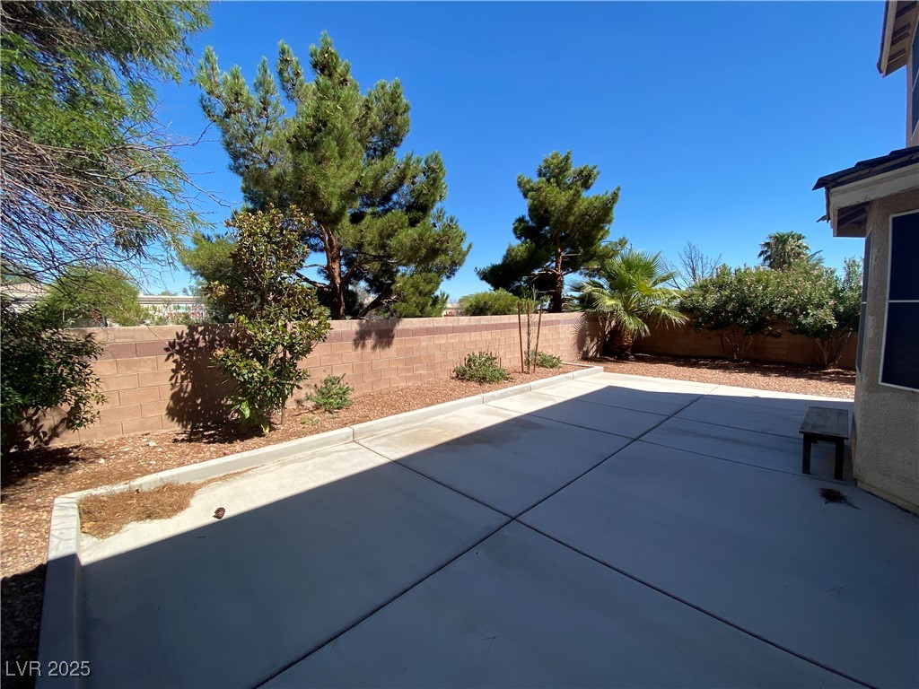 5680 Arrow Tree Street Las Vegas, NV 89130 - Photo 25 of 27 Fenced backyard with a patio