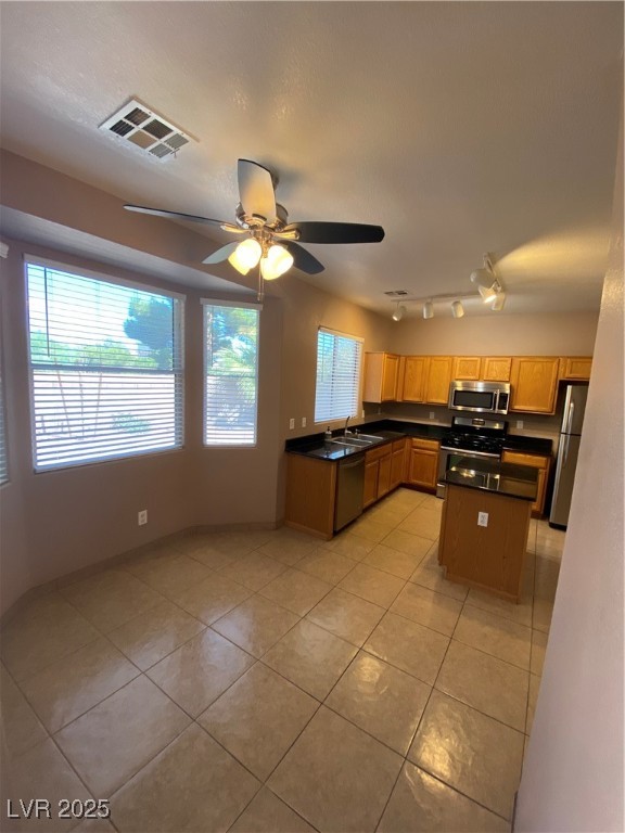 5680 Arrow Tree Street Las Vegas, NV 89130 - Photo 8 of 27 Kitchen with dark countertops, stove, light tile patterned flooring, and fridge