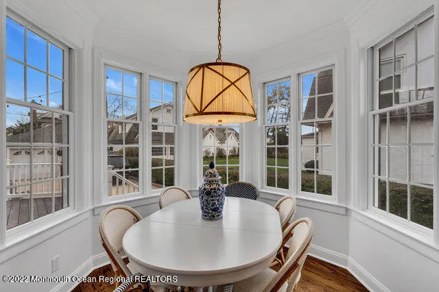 a view of a dining room with furniture wooden floor and a chandelier