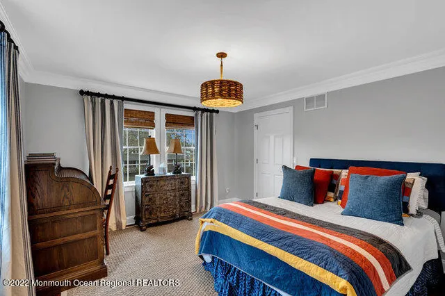 a bedroom with a bed and a chandelier