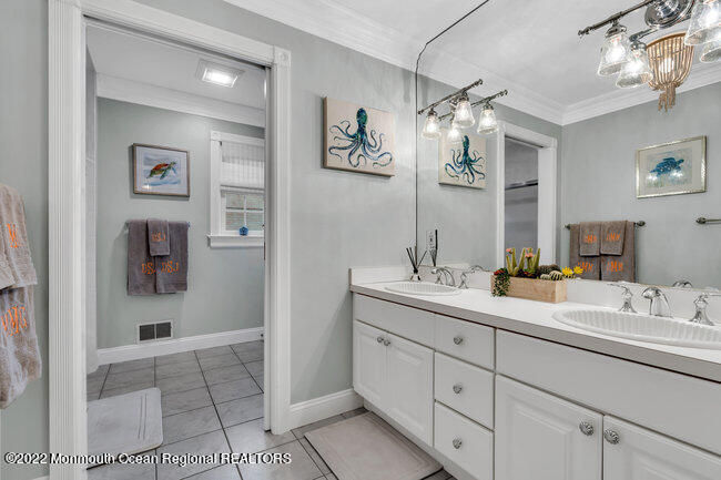 312 Essex Avenue Spring Lake, NJ 07762 - Photo 21 of 29 a bathroom with a double vanity sink mirror and next to a window