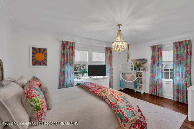 a bedroom with bed and a chandelier