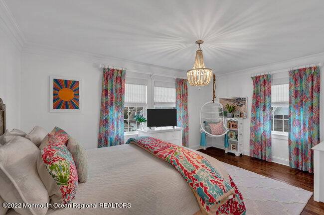 312 Essex Avenue Spring Lake, NJ 07762 - Photo 23 of 29 a bedroom with bed and a chandelier