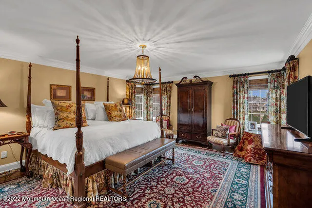 a bed room with furniture and a flat screen tv