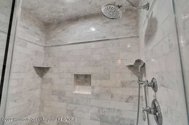 a room with furniture pool table flat screen tv and couches