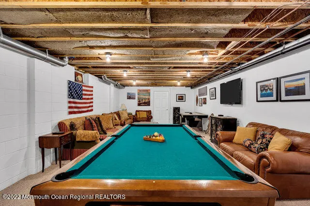 a view of a patio with table and chairs with wooden floor and fence
