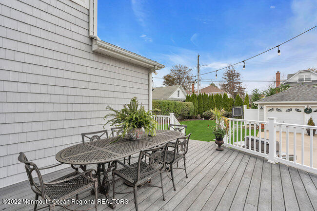 312 Essex Avenue Spring Lake, NJ 07762 - Photo 28 of 29 a view of a patio with table and chairs with wooden floor and fence