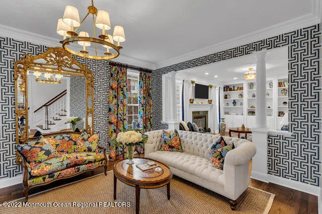 a living room with fireplace furniture and a chandelier