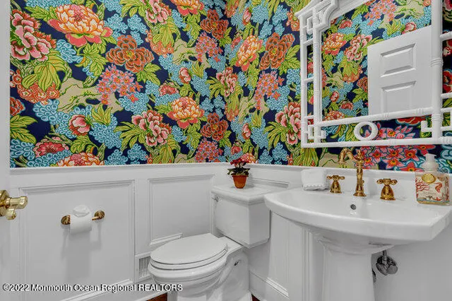 a bathroom with a sink toilet and a shower curtain