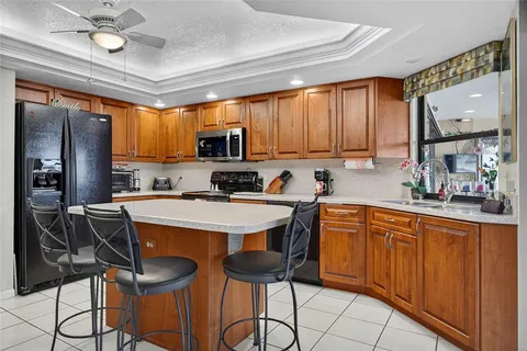 a kitchen with stainless steel appliances a stove a sink refrigerator and microwave