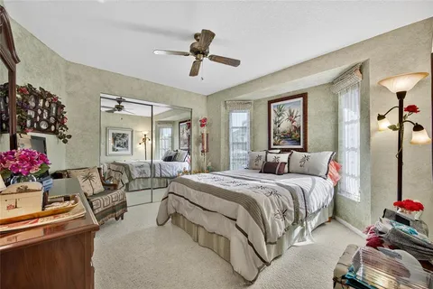 a bedroom with a bed gym equipment and a chandelier