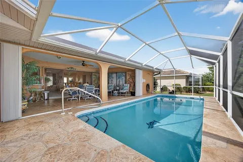 a swimming pool with outdoor seating