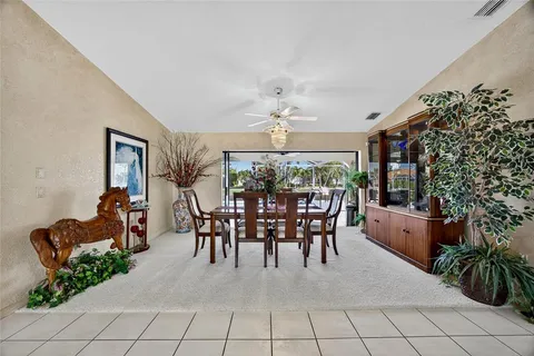 a dining room with furniture and a chandelier