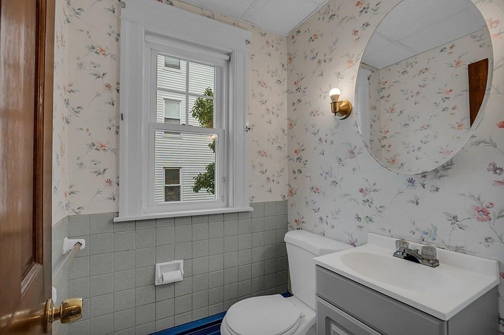 15 Halmstad Street Worcester, MA 01607 - Photo 16 of 25 a bathroom with a sink a toilet and a mirror