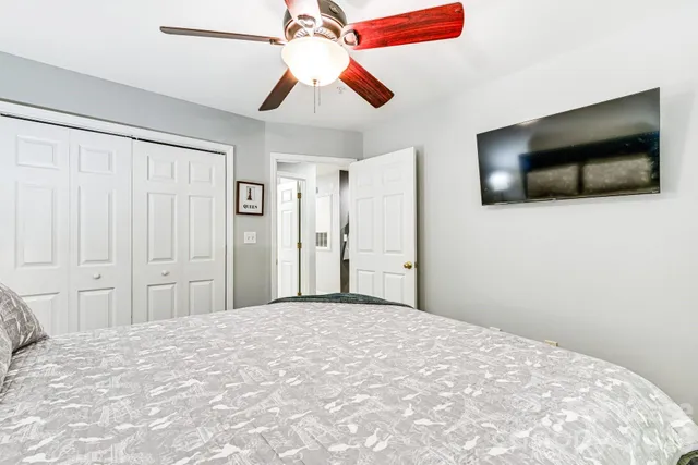 a bedroom with a bed and a flat screen tv