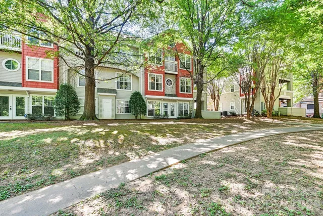 a red brick house with trees in front of it