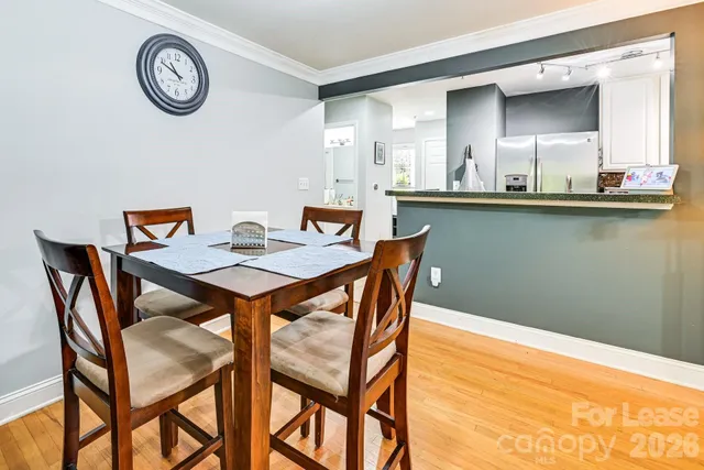 a view of a dining room with furniture and a chandelier