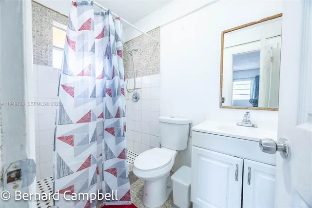 a room with a bed and a mirror on dresser