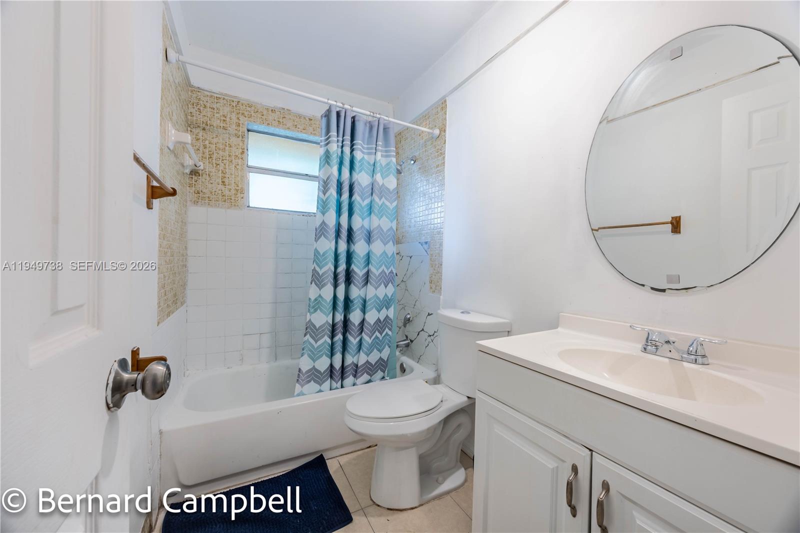 129 Southeast 5th Street, Unit 14 Hallandale Beach, FL 33009 - Photo 22 of 32 a bathroom with a sink a toilet and a mirror