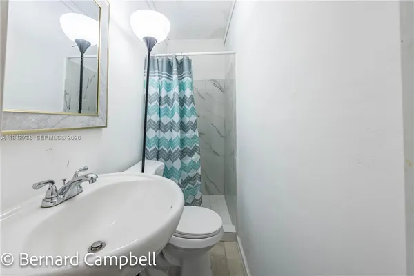 a white toilet sitting next to a bathroom sink