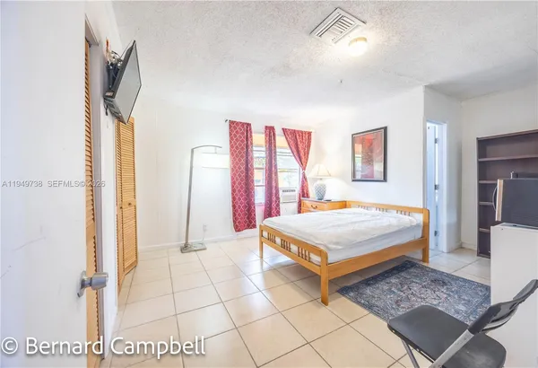 a bedroom with a bed and a rug