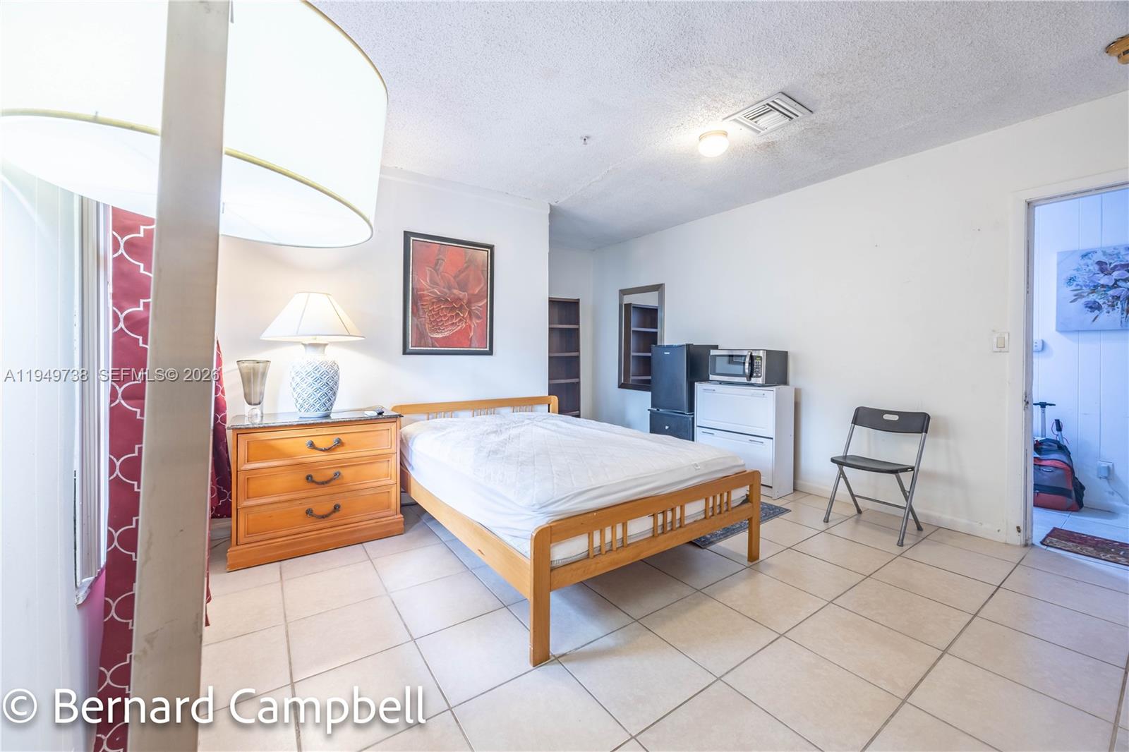 129 Southeast 5th Street, Unit 14 Hallandale Beach, FL 33009 - Photo 10 of 32 a room with furniture and mirror