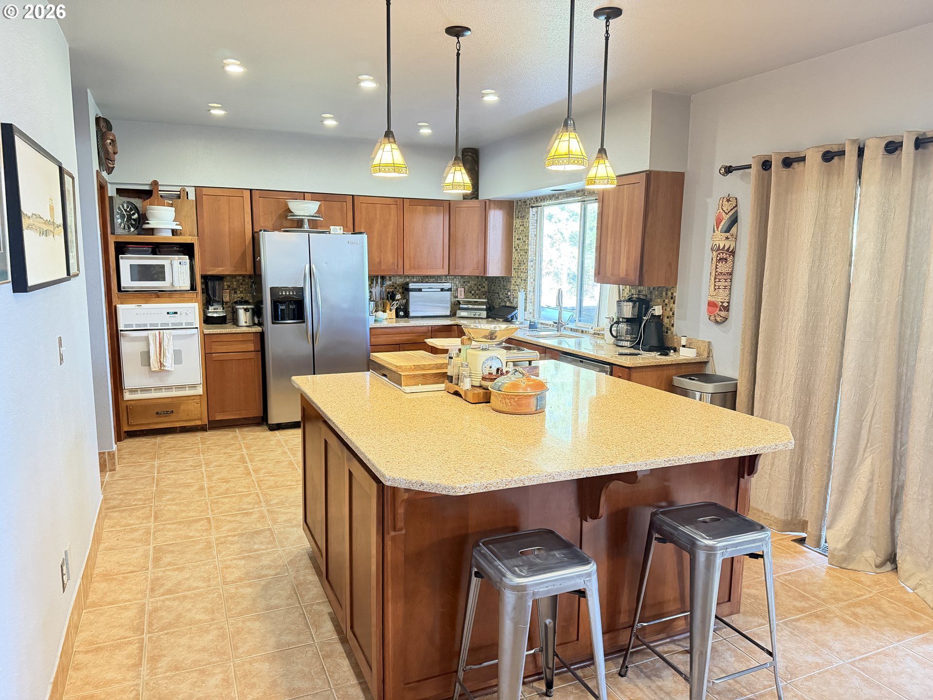31890 Cater Road Warren, OR 97053 - Photo 28 of 38 a kitchen with stainless steel appliances kitchen island granite countertop a sink refrigerator and cabinets