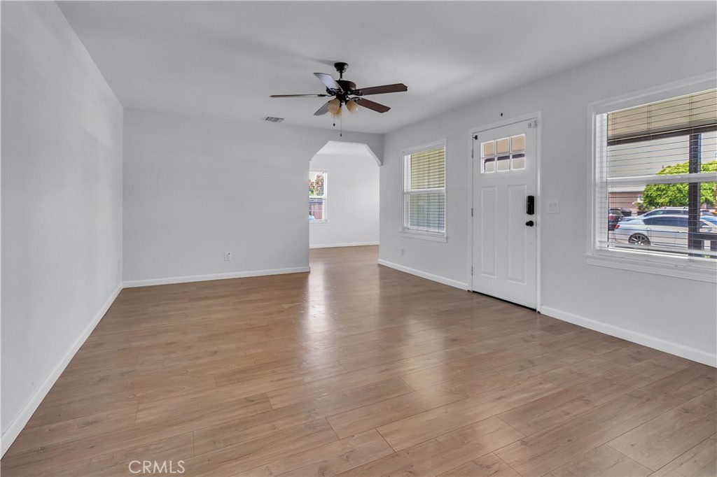 7552 11th Street Buena Park, CA 90621 - Photo 11 of 23 a view of a livingroom with wooden floor and a ceiling fan