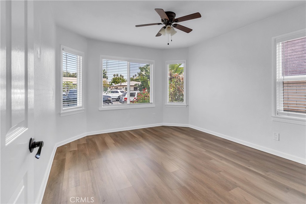7552 11th Street Buena Park, CA 90621 - Photo 12 of 23 a view of empty room with wooden floor and fan