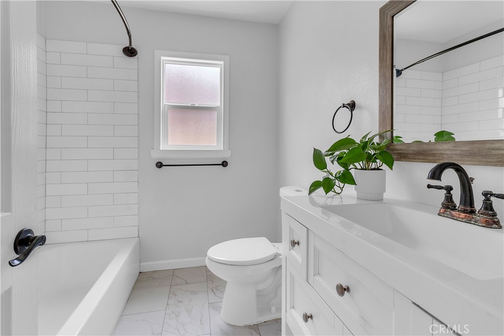 7552 11th Street Buena Park, CA 90621 - Photo 14 of 23 a bathroom with a sink a toilet and tub