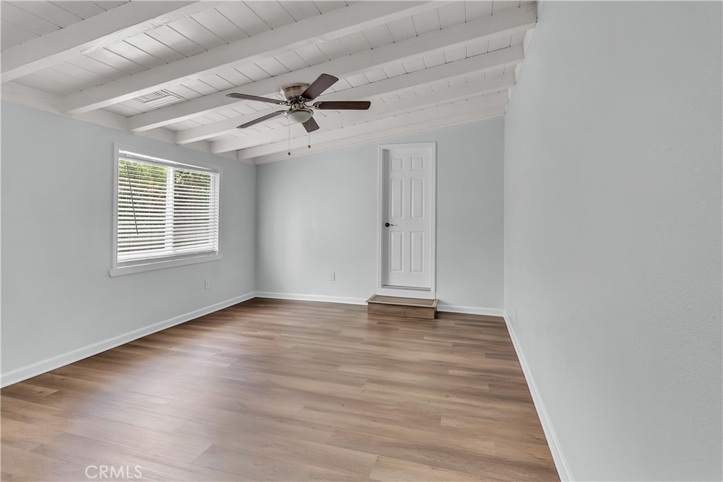 7552 11th Street Buena Park, CA 90621 - Photo 17 of 23 a view of an empty room with a window and wooden floor