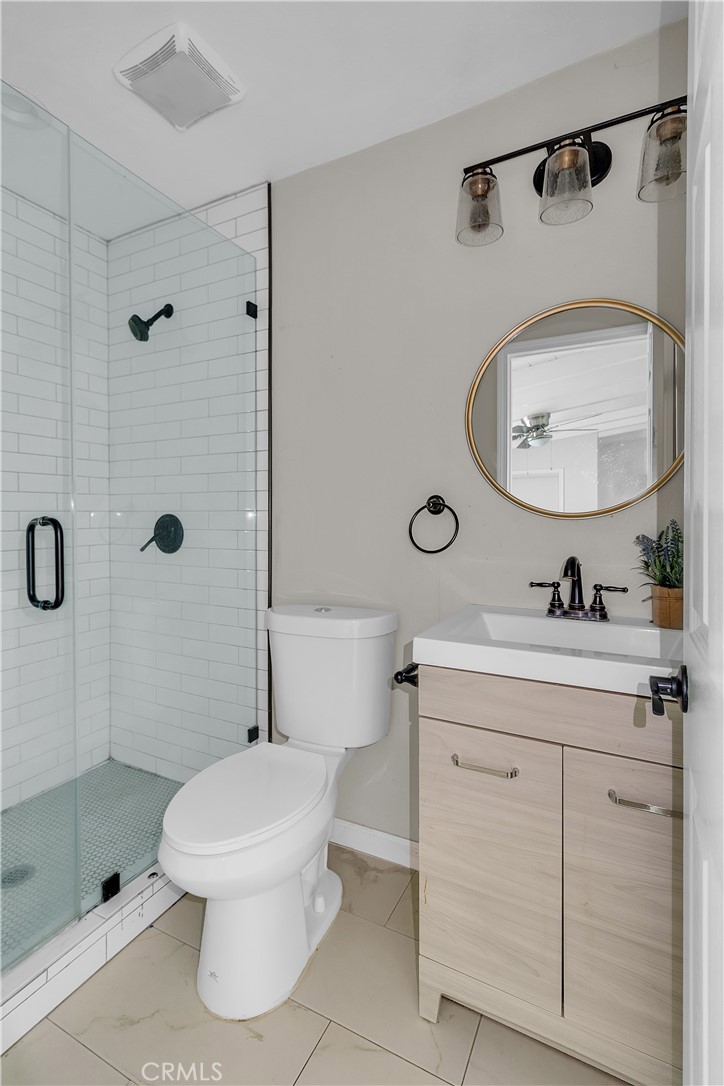 7552 11th Street Buena Park, CA 90621 - Photo 19 of 23 a bathroom with a toilet sink shower and mirror