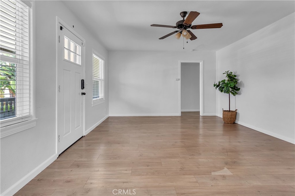 7552 11th Street Buena Park, CA 90621 - Photo 5 of 23 a view of an empty room and window with wooden floor