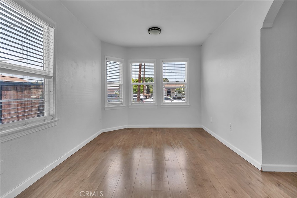 7552 11th Street Buena Park, CA 90621 - Photo 6 of 23 an empty room with wooden floor and windows