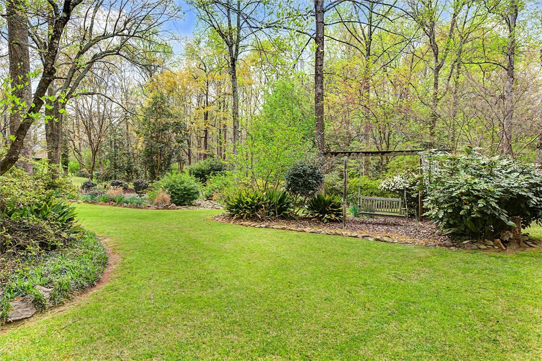 105 Hamilton Drive Anderson, SC 29621 - Photo 12 of 49 This verdant outdoor space offers a tranquil retreat with a charming swing.