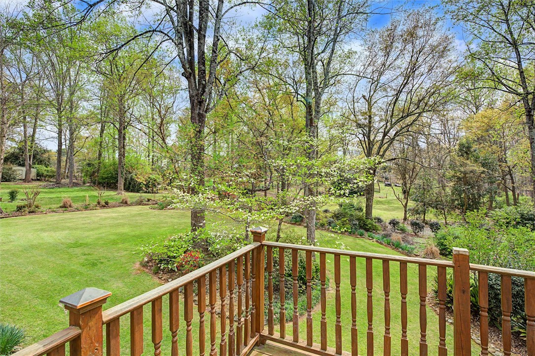 105 Hamilton Drive Anderson, SC 29621 - Photo 13 of 49 This tranquil setting features a lush green yard surrounded by mature trees, creating a serene outdoor escape.