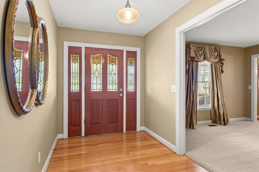 105 Hamilton Drive Anderson, SC 29621 - Photo 14 of 49 This inviting entry features rich wood flooring and a classic door with decorative glass.