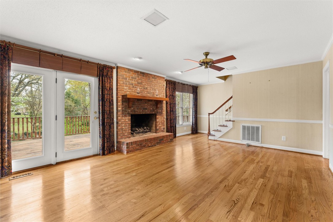 105 Hamilton Drive Anderson, SC 29621 - Photo 16 of 49 This airy living space features polished hardwood floors, a brick fireplace, and direct deck access.