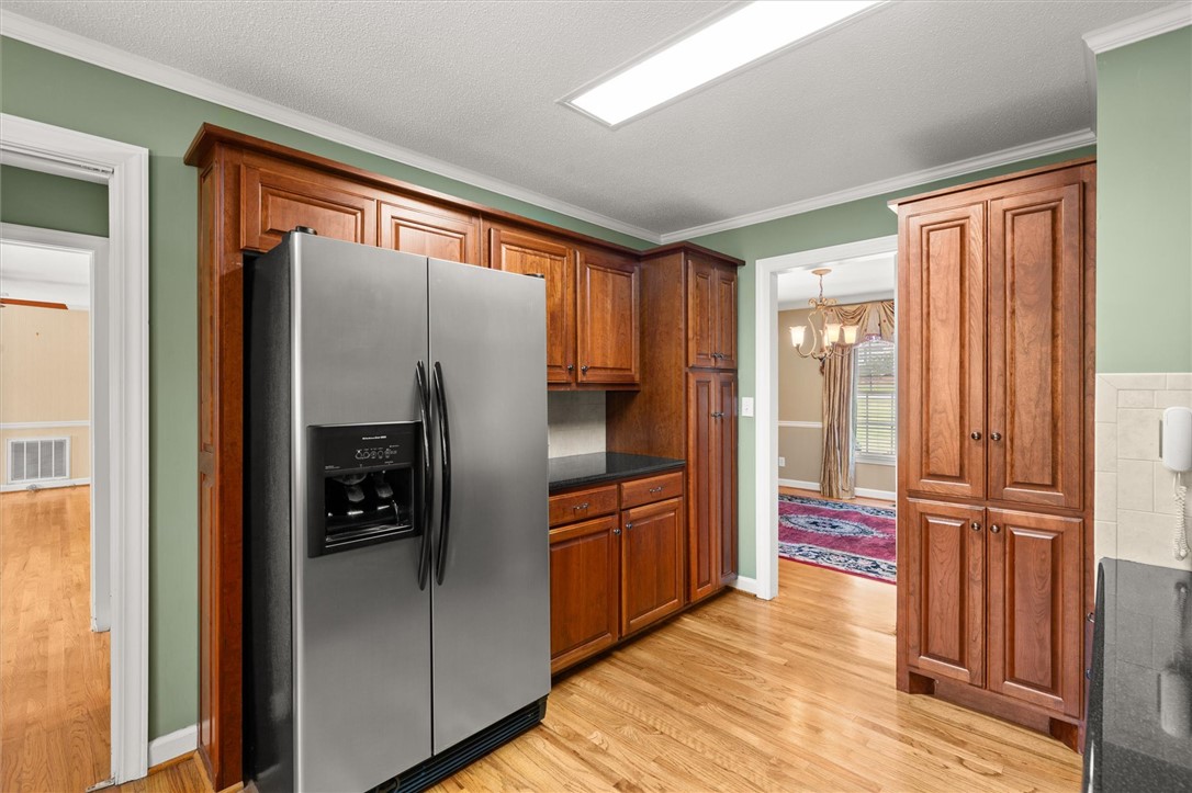 105 Hamilton Drive Anderson, SC 29621 - Photo 23 of 49 This spacious kitchen features ample cabinetry and beautiful hardwood floors, offering both style and functionality.