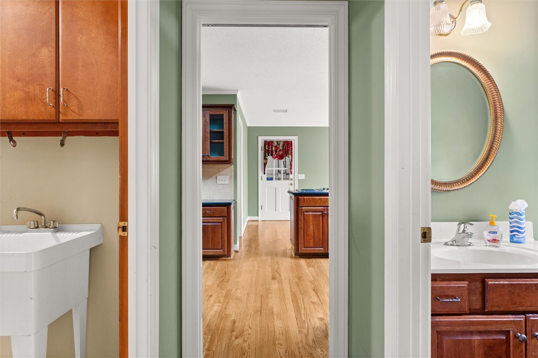 105 Hamilton Drive Anderson, SC 29621 - Photo 26 of 49 This interior image showcases a utility sink and a view into an adjacent kitchen area.