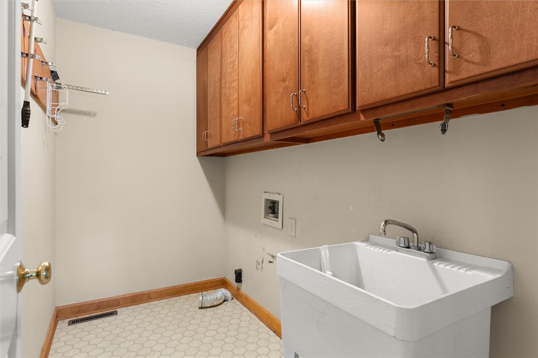 105 Hamilton Drive Anderson, SC 29621 - Photo 27 of 49 Functional laundry space with storage cabinets and a utility sink.