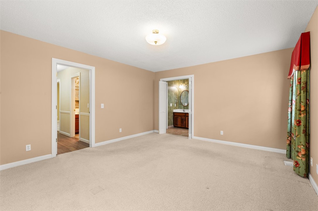 105 Hamilton Drive Anderson, SC 29621 - Photo 32 of 49 This inviting bedroom features soft carpeting, neutral walls, and a convenient ensuite bathroom access.