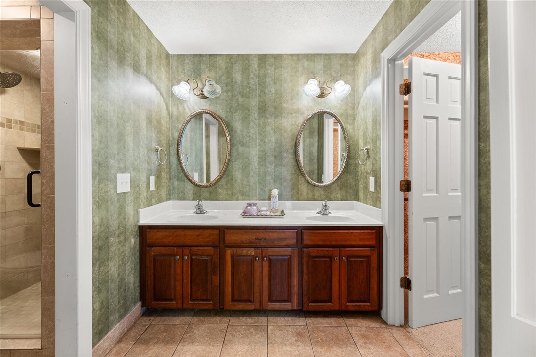 105 Hamilton Drive Anderson, SC 29621 - Photo 34 of 49 This bathroom features a double vanity and a glass-enclosed shower, offering comfort and convenience.