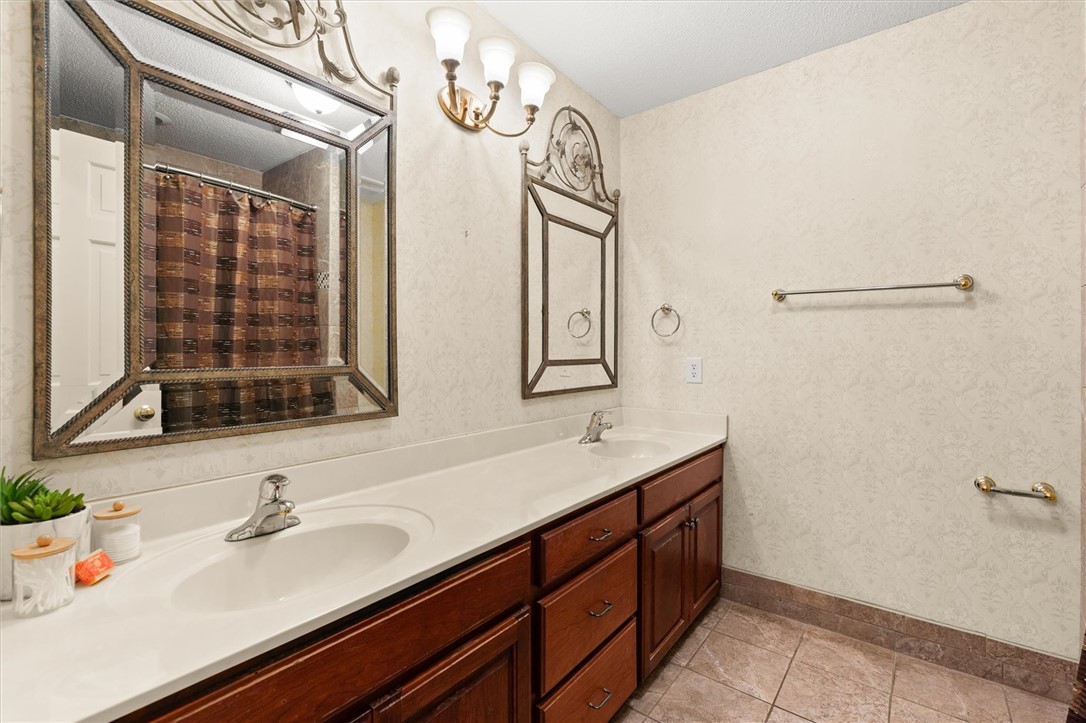 105 Hamilton Drive Anderson, SC 29621 - Photo 41 of 49 This bathroom features a double vanity and classic tiled flooring.