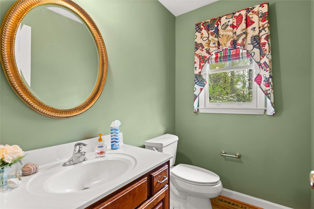 105 Hamilton Drive Anderson, SC 29621 - Photo 47 of 49 This half bathroom features a simple vanity, toilet, and window, offering a functional space.