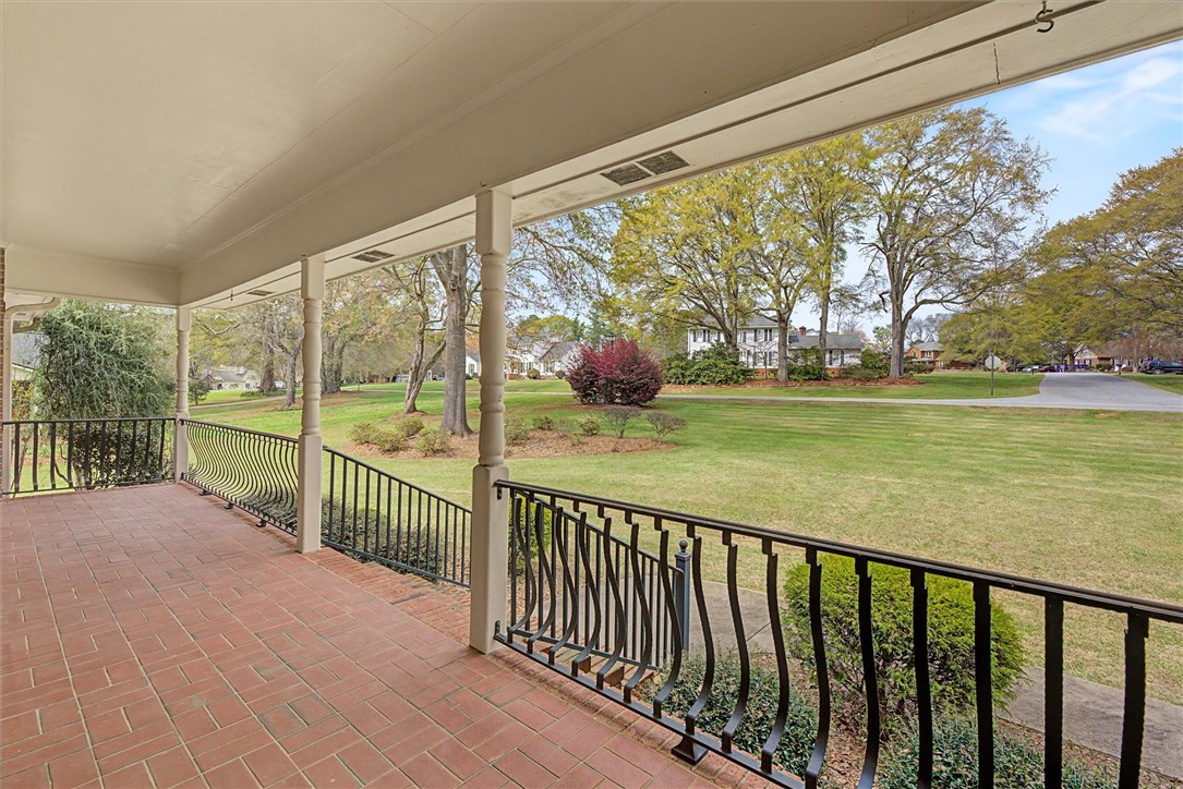 105 Hamilton Drive Anderson, SC 29621 - Photo 5 of 49 Relax on this charming porch overlooking a sprawling green lawn with mature trees.